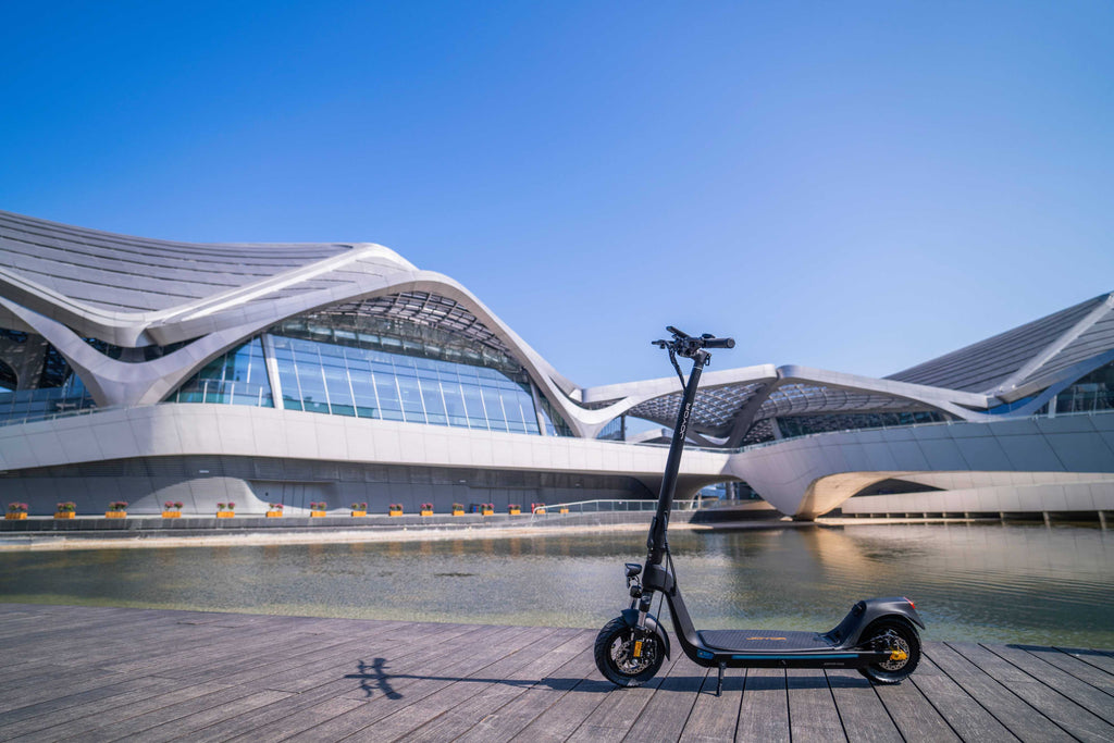 Electric scooter on a wooden platform with modern architectural building in the background