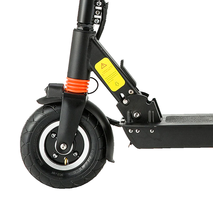 Close-up of a black joyor f1 electric scooter showing the front wheel, fork, orange shock absorber, yellow warning label, and part of the deck on a white background.