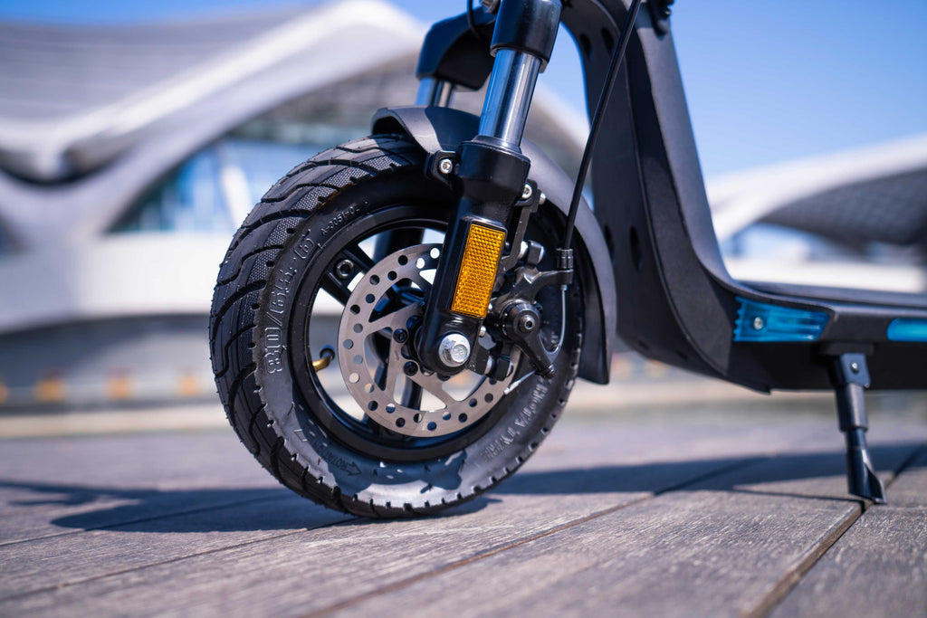 Close-up of an electric scooter's wheel on a blurred background