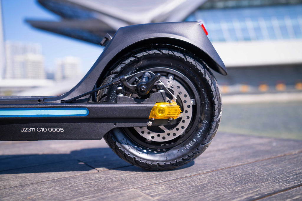 Close-up of a scooter wheel with a blurred background